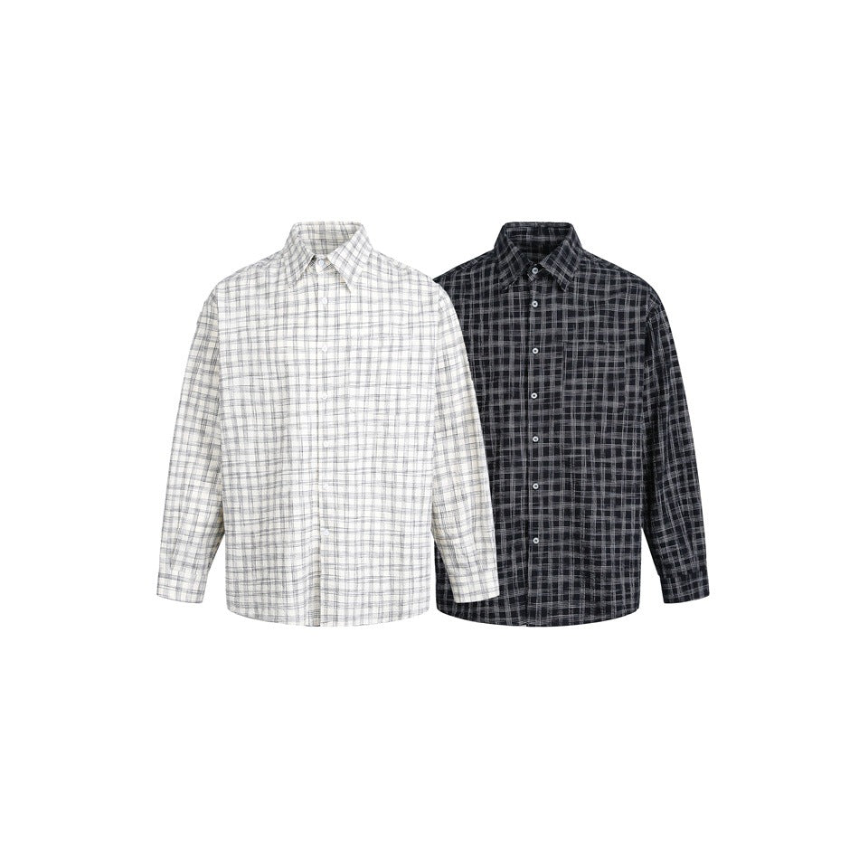 Two button-up plaid shirts shown side by side: one light gray and white, the other black and gray.