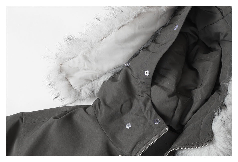 Close-up of a charcoal coat showing white faux-fur hood trim, snap buttons, and a zipper.