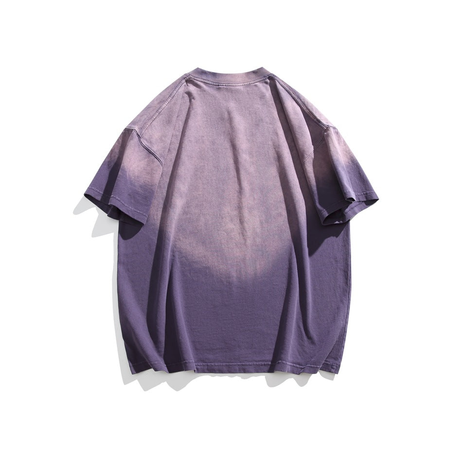 Back view of a loose purple washed short-sleeve T-shirt on a white background.
