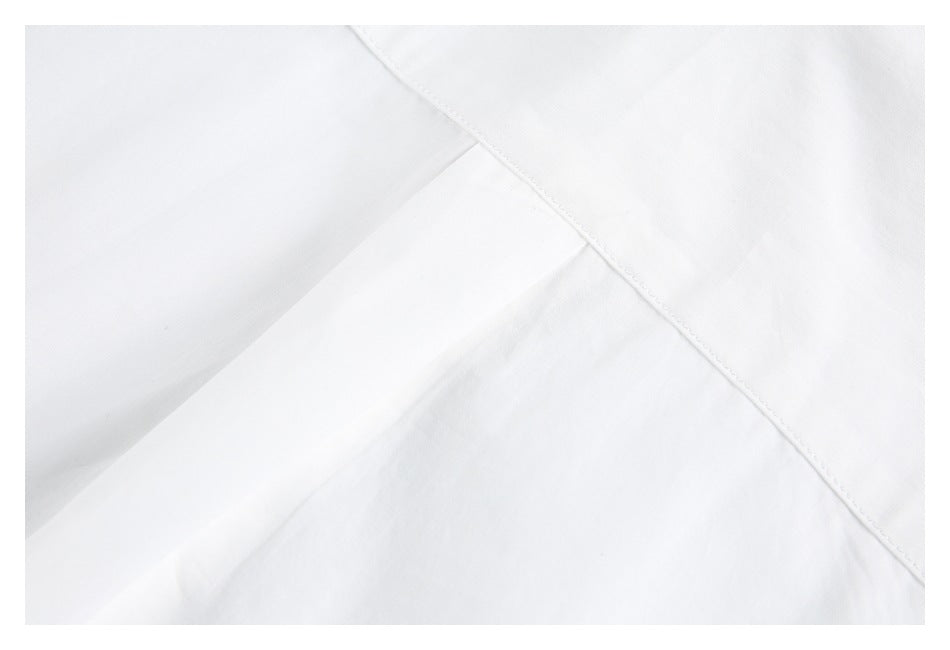 Close-up of a diagonal stitched seam on white garment fabric.