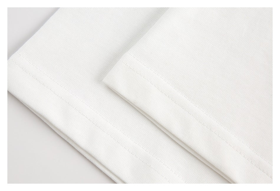 Close-up of the stitched hem on white fabric.