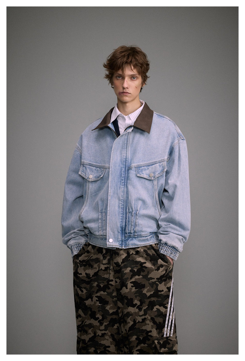 Model wearing a light blue denim jacket with a dark brown collar, flap chest pockets and gathered cuffs.