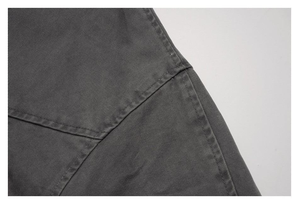 Close-up of a charcoal jacket shoulder seam and panel stitching.
