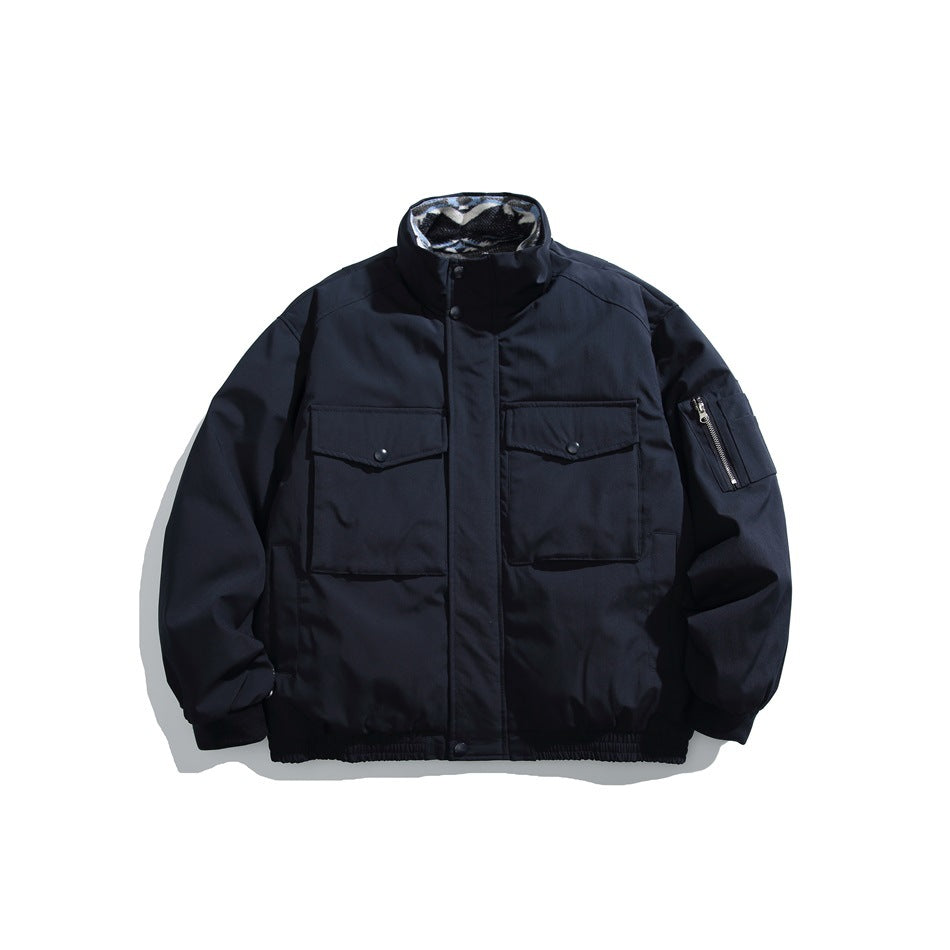 Front view of a dark navy jacket with a high collar, snap-flap chest pockets, a zippered sleeve pocket and gathered hem.