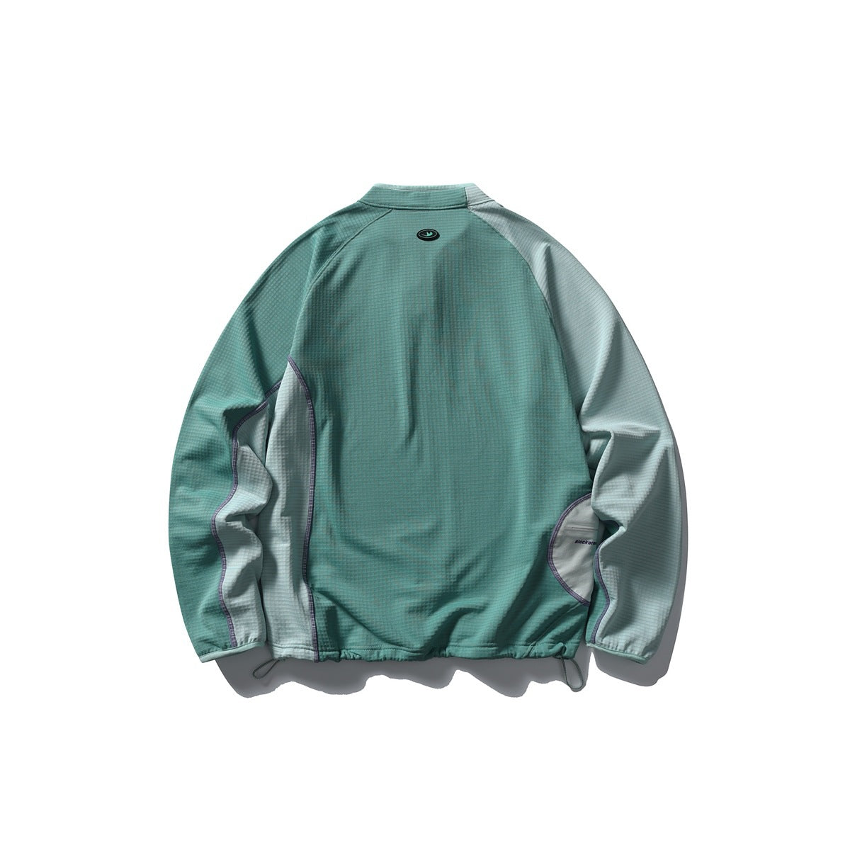 Back view of a teal color-block jacket with pale gray sleeves, curved seam panels, and an elastic drawcord hem.