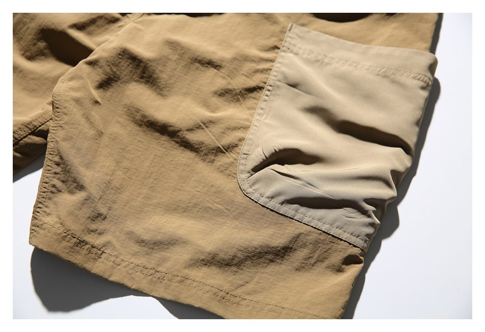 Close-up of a large light-tan patch pocket on tan shorts.
