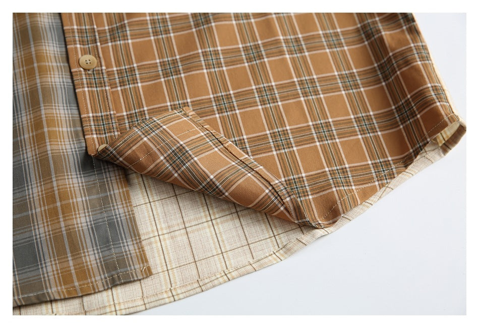 Close-up of a brown plaid shirt hem and pocket with contrasting gray and cream plaid panels.