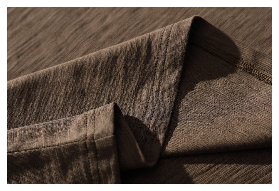 Close-up of brown shirt neckline stitching and the inside seam.