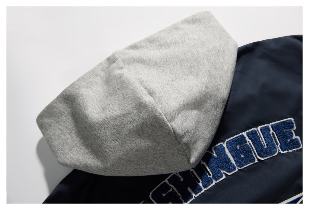 Close-up of a gray hood beside a navy jacket with raised blue-and-white lettering.