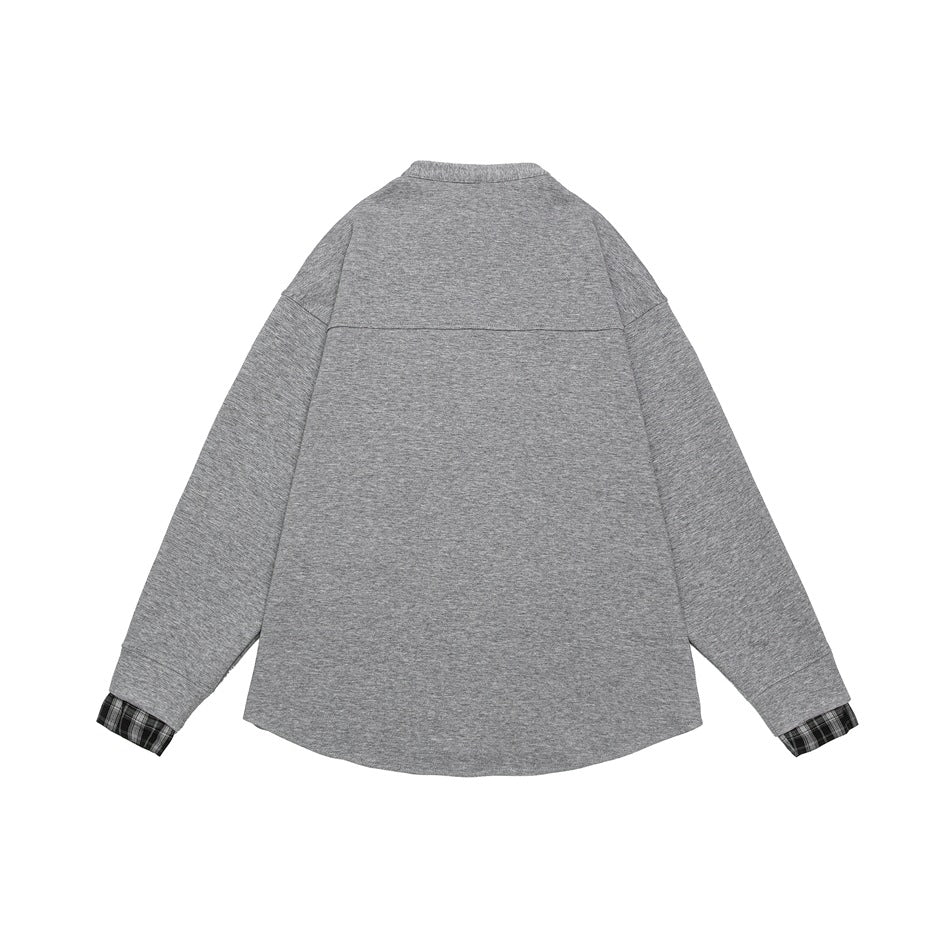 Back view of a heather-gray long-sleeved shirt with a short stand collar and black-and-white plaid cuff inserts.