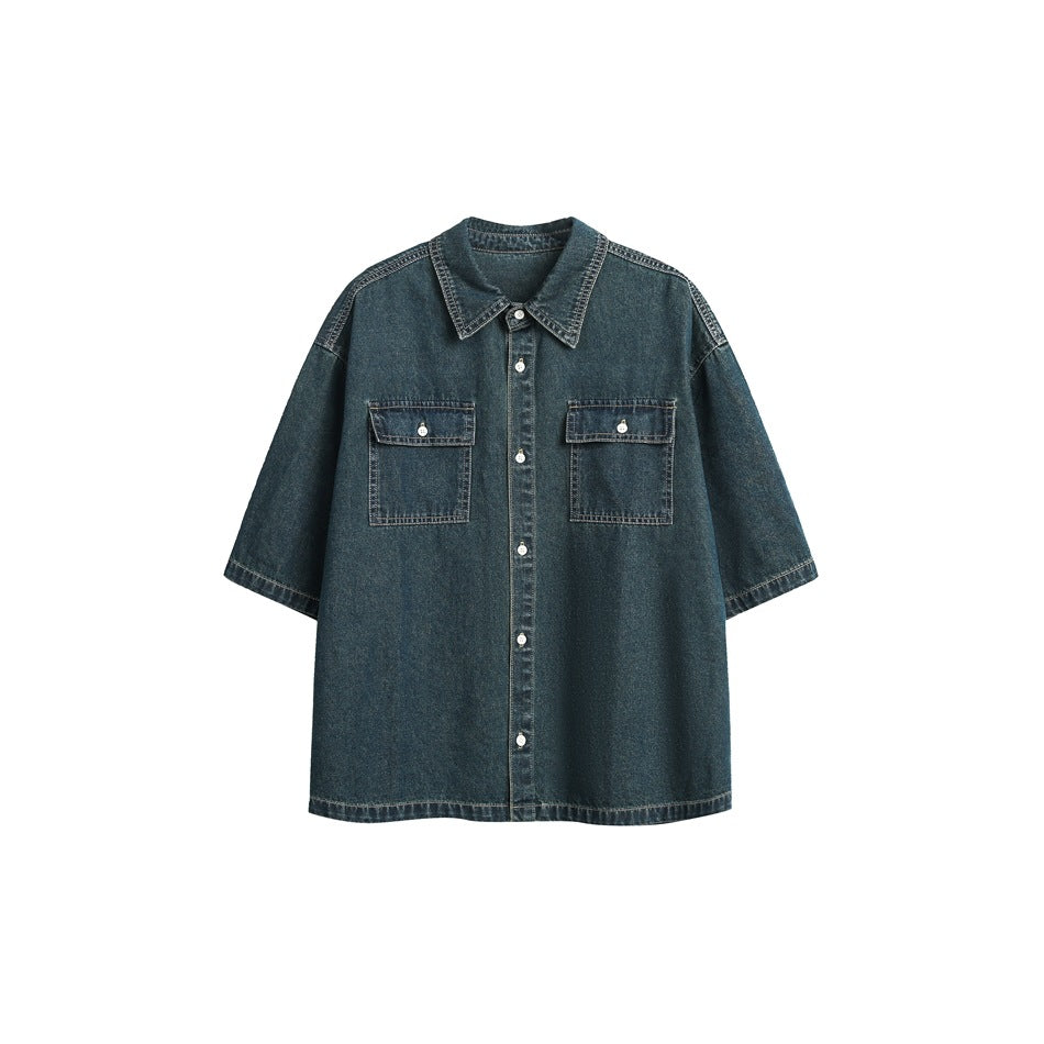 Dark blue washed denim short-sleeve shirt, flat front view with two button flap chest pockets and button placket