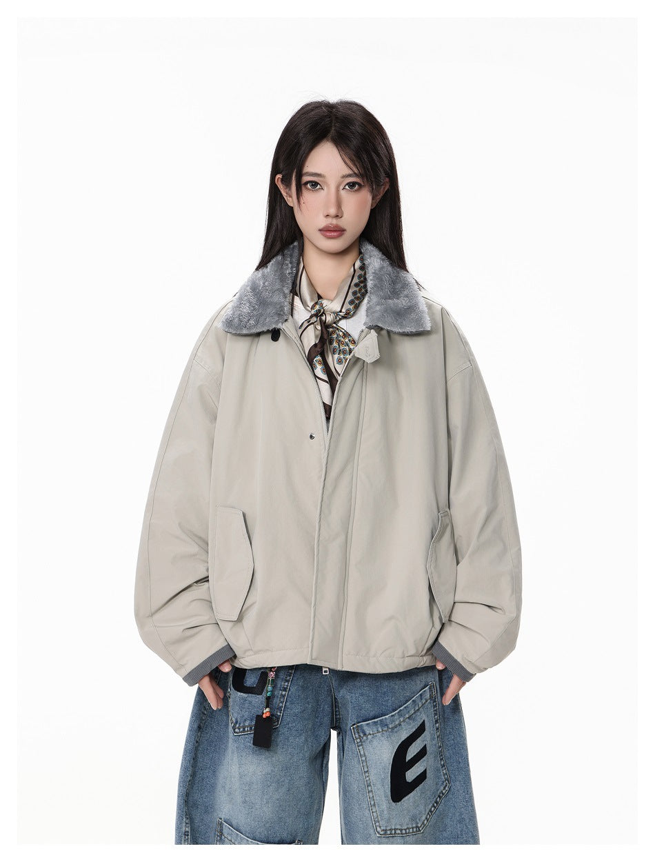 Model wearing a light gray jacket with a gray fleece-like collar over a scarf and wide-leg jeans, front view