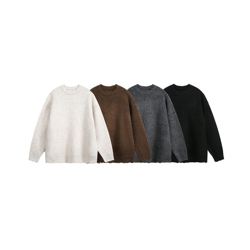 Four plain crew-neck sweaters arranged side by side in ivory, brown, charcoal gray, and black.