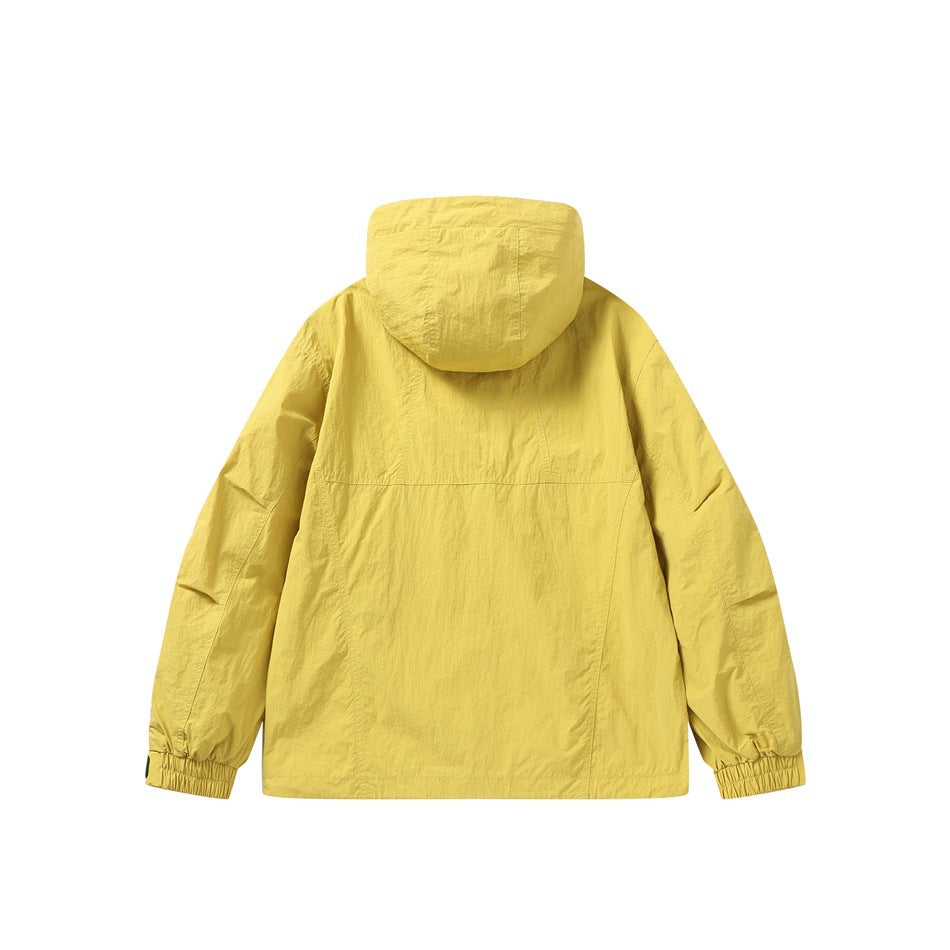 Back view of a yellow hooded jacket with elastic cuffs and a horizontal seam across the back.