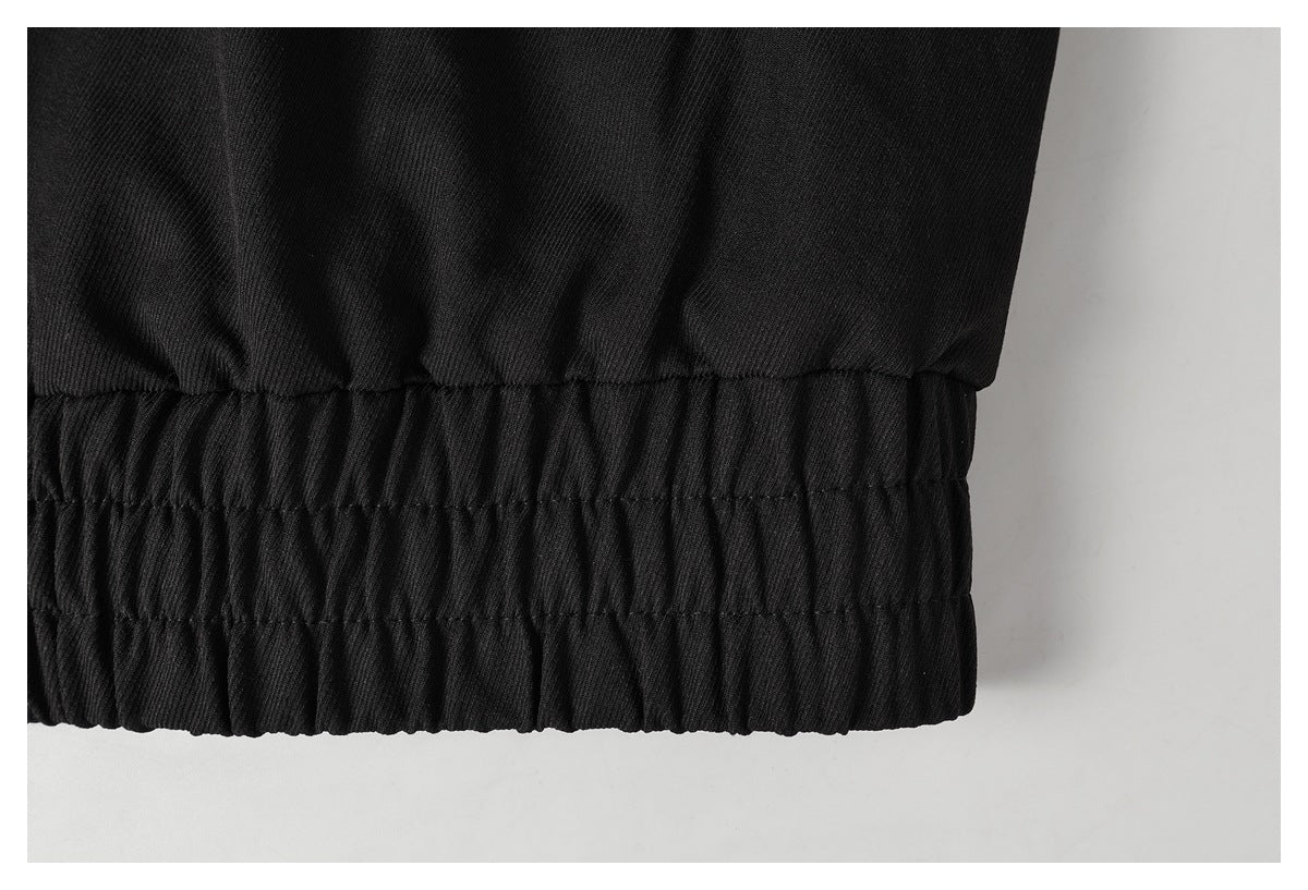 Close-up of the black garment's gathered elastic hem.