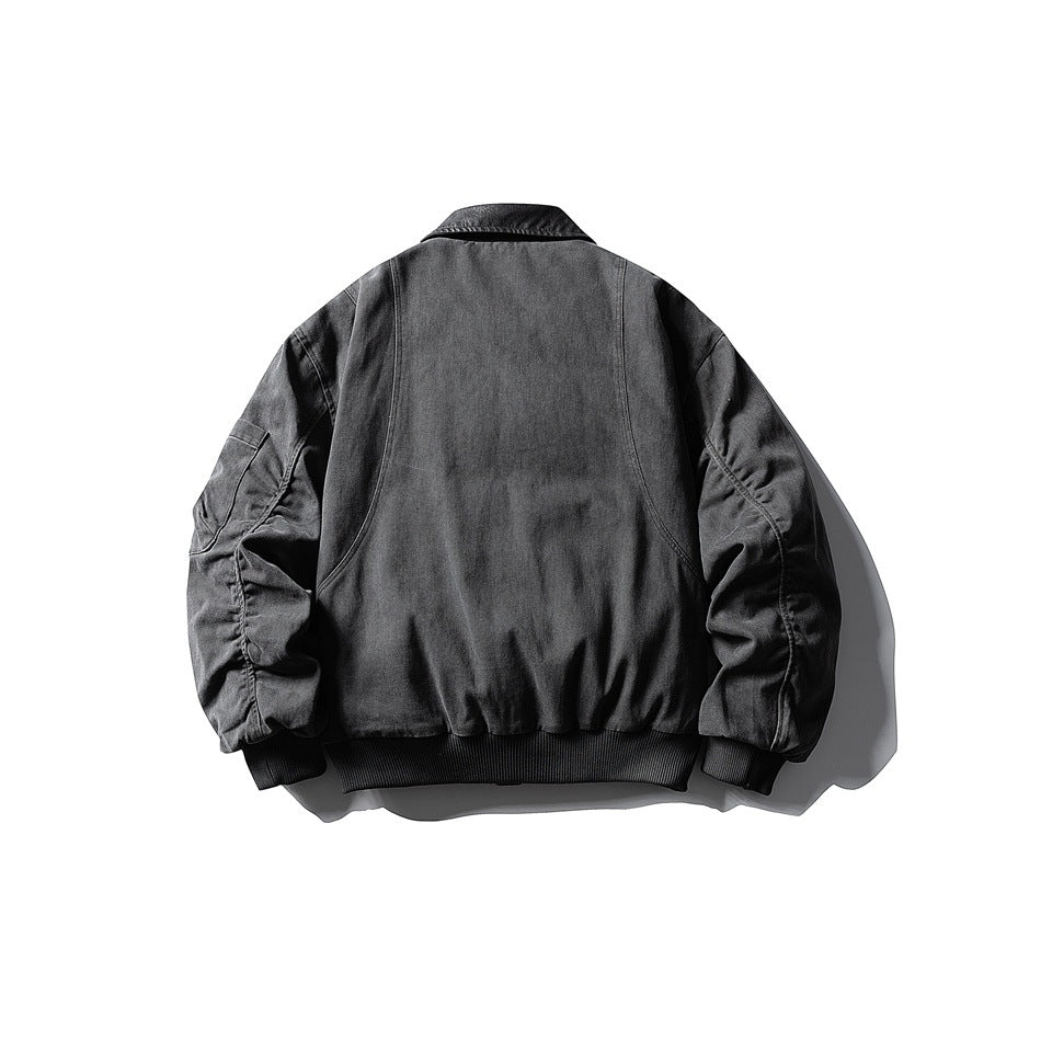 Back view of a dark gray jacket with gathered sleeves and a black ribbed hem and cuffs.