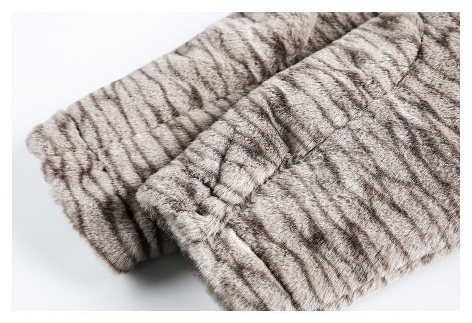 Close-up of a folded sleeve or cuff on a gray-brown striped fur garment.