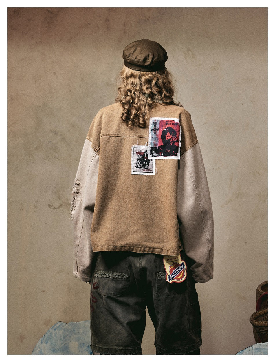 Back view of a model wearing a brown jacket with pale sleeves and graphic patches across the upper back.