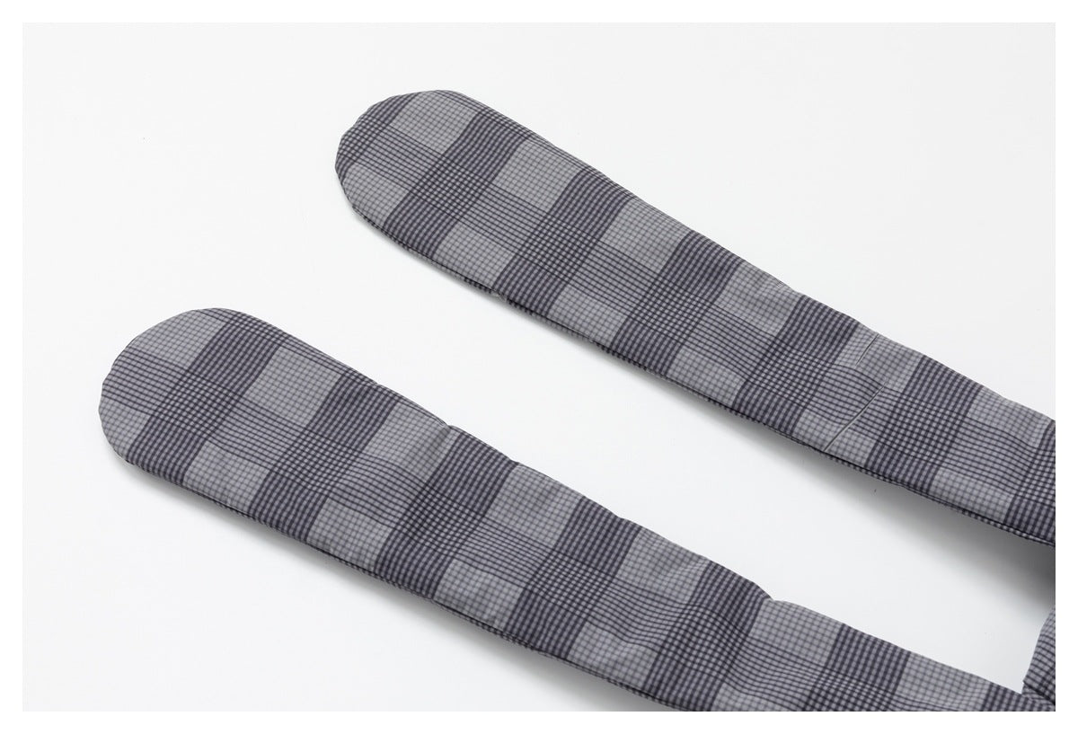 Two long, narrow sections of gray and black checked fabric laid flat on a white background.