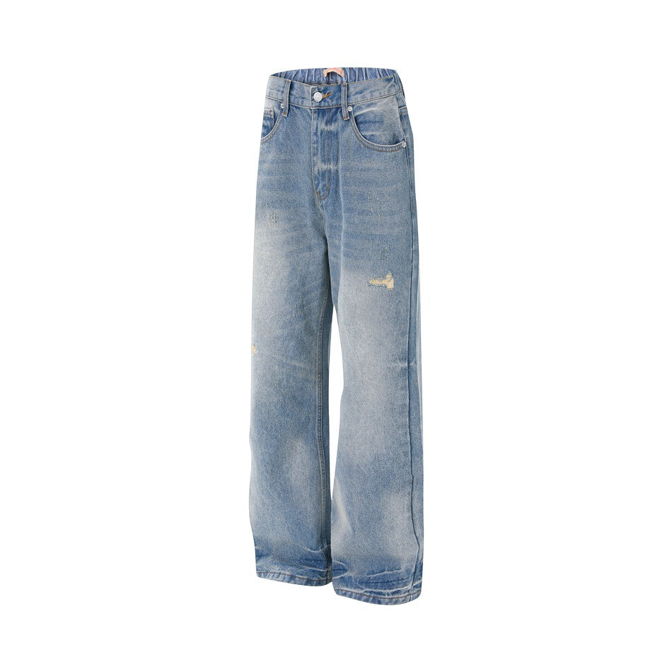 Angled three-quarter view of light blue washed wide-leg jeans with faded areas and distressed patches