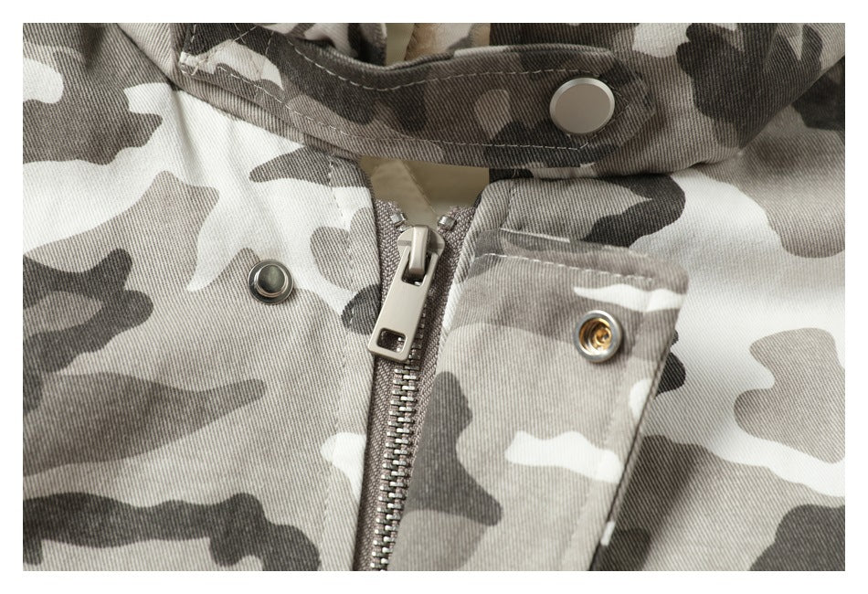 Close-up of the jacket's metal zipper and snap fastenings beneath a camouflage collar flap.