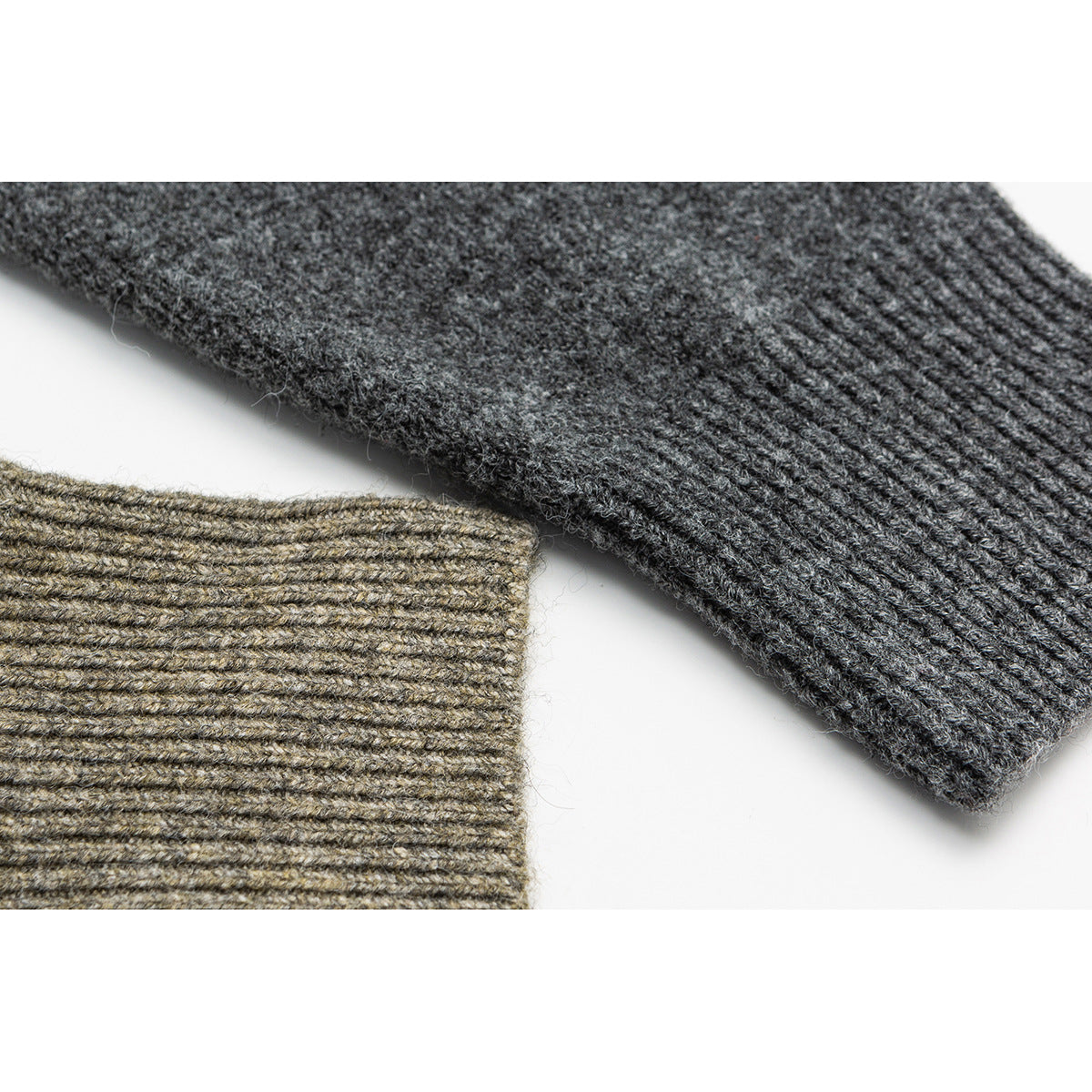 Close-up of charcoal and taupe knit sweater cuffs showing ribbed edges and textured stitches.