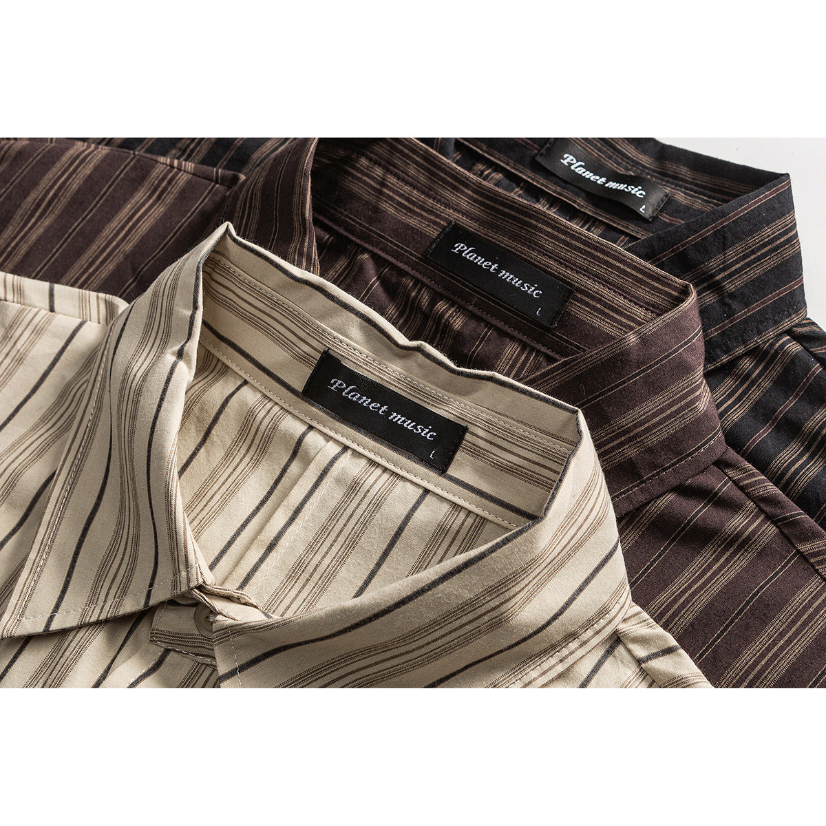 Close-up of three collared shirts in beige, brown, and dark brown with narrow vertical stripes and visible neck labels.