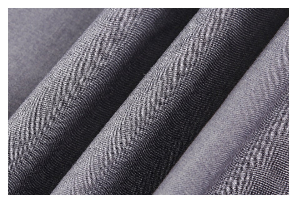 Extreme close-up of gray woven garment fabric arranged in soft folds.