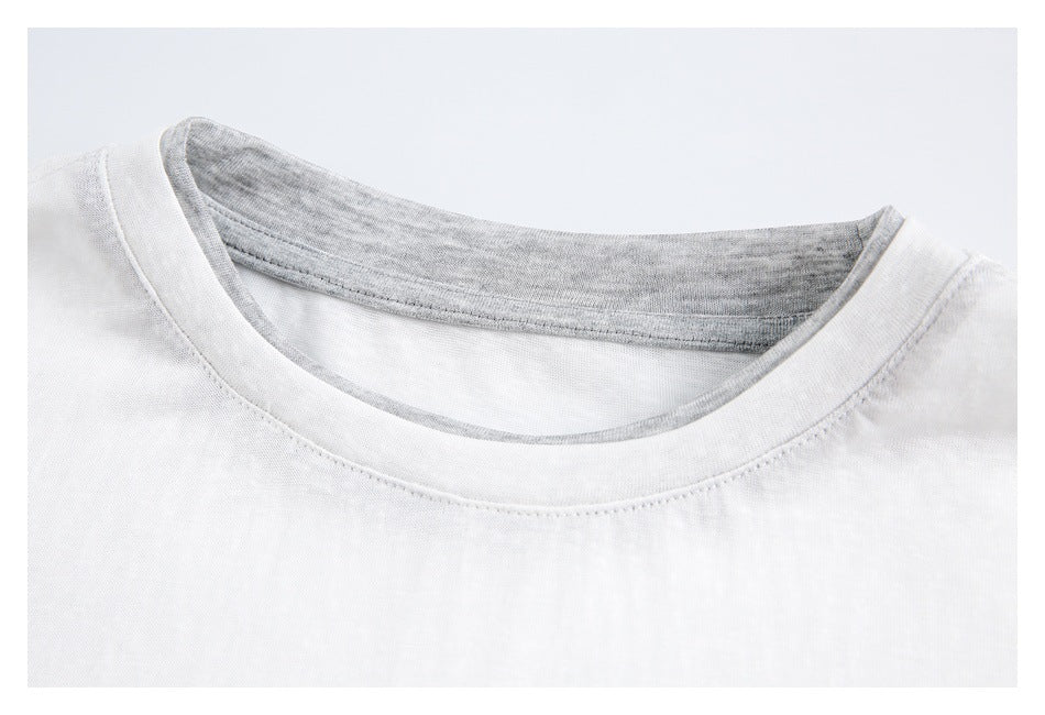 Close-up of a white shirt's crew neckline with gray inner binding and stitching.