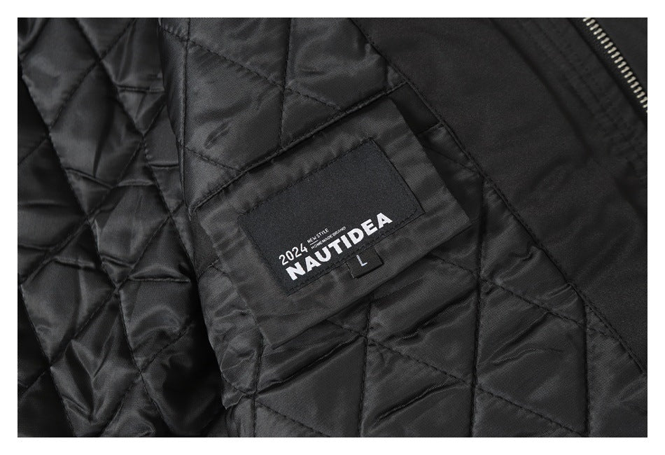 Close-up of a sewn English-text brand and size label on the jacket's diamond-quilted lining.