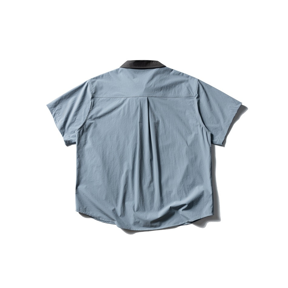 Back view of a light blue short-sleeve shirt with a charcoal collar, shoulder yoke and center pleat.