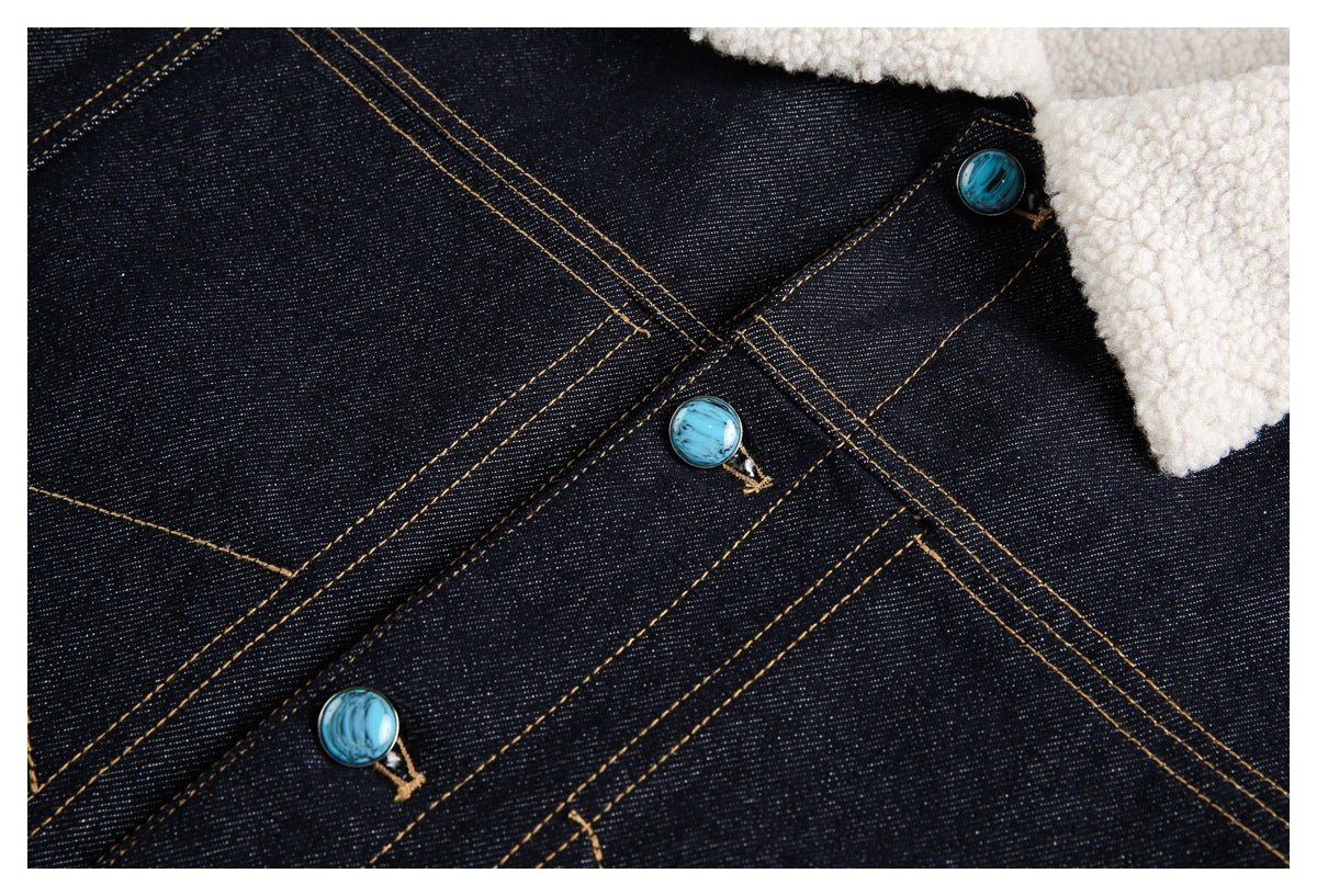 Close-up of turquoise buttons and contrast stitching on dark denim beneath the cream sherpa collar.