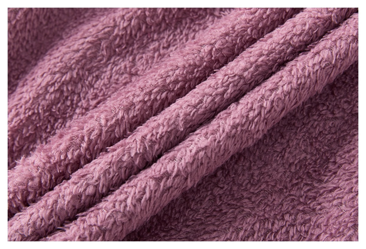Close-up of plush mauve-pink fabric with a thick, looped texture and folded ridges.