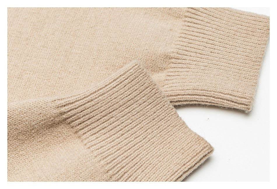 Close-up of a beige sweater sleeve and broad ribbed cuff.