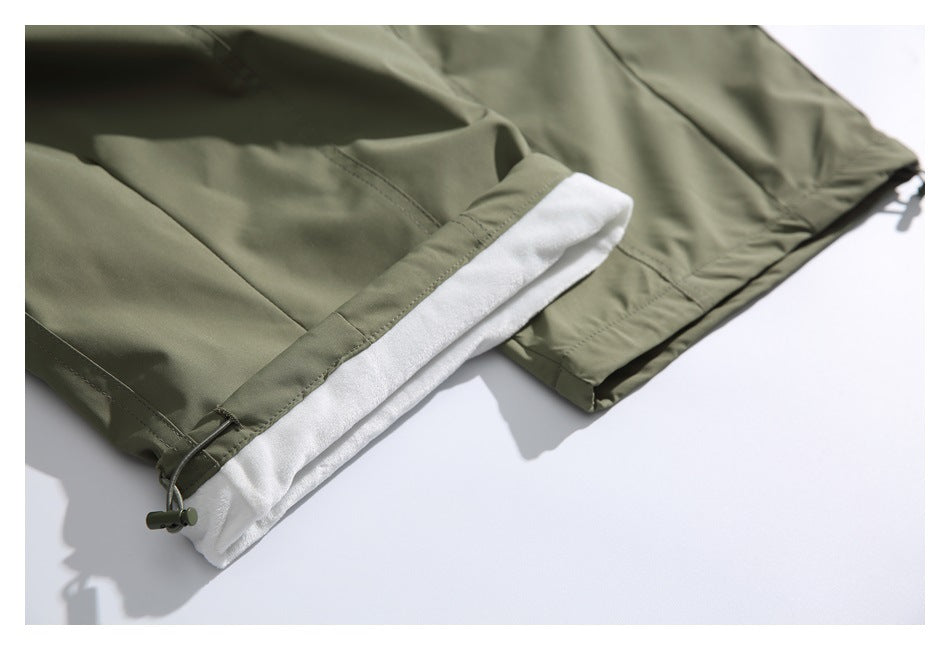 Olive-green garment edge folded back to show white lining and an adjustable drawcord.