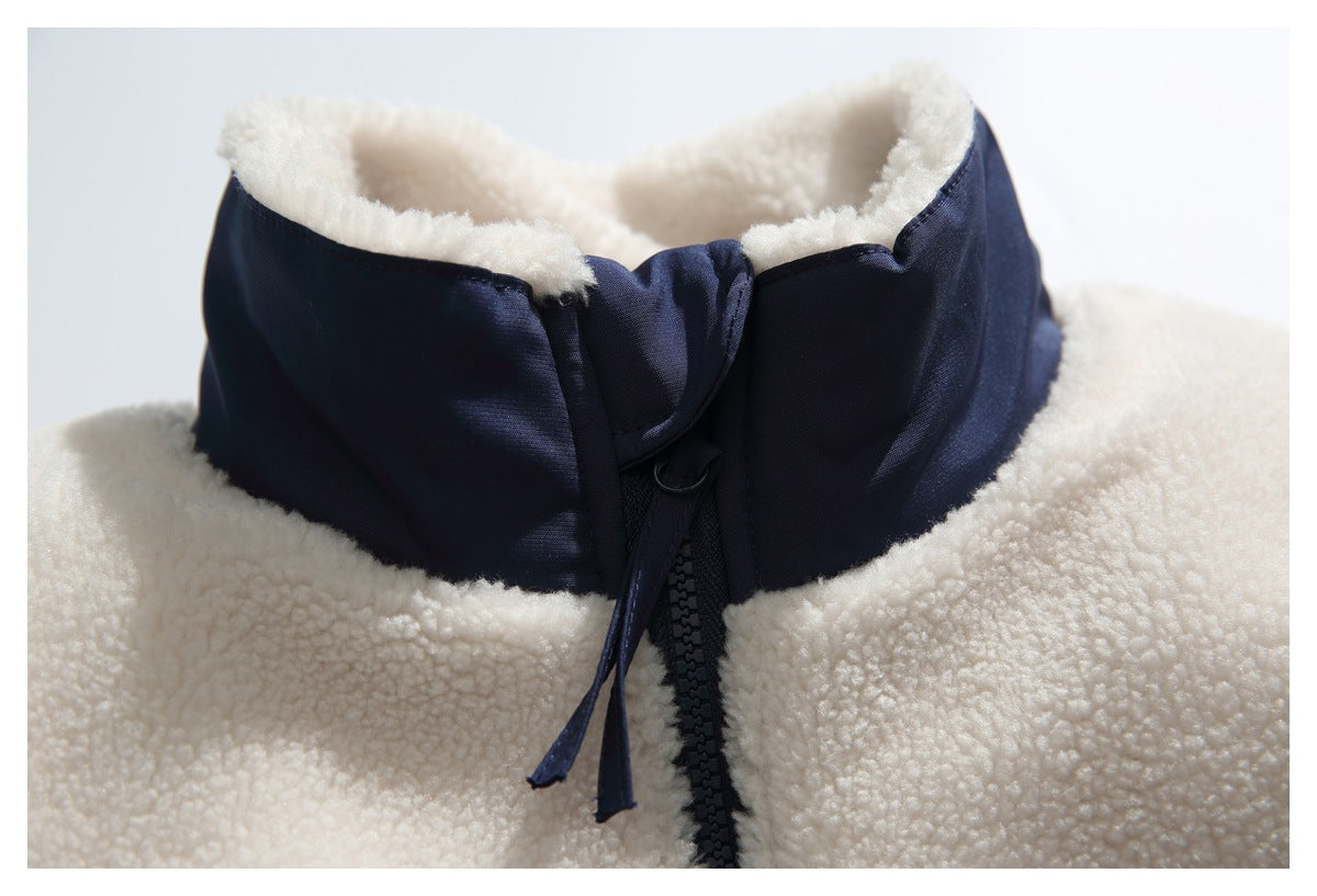 Close-up of the jacket's navy stand collar, ivory fleece lining, and front zipper.