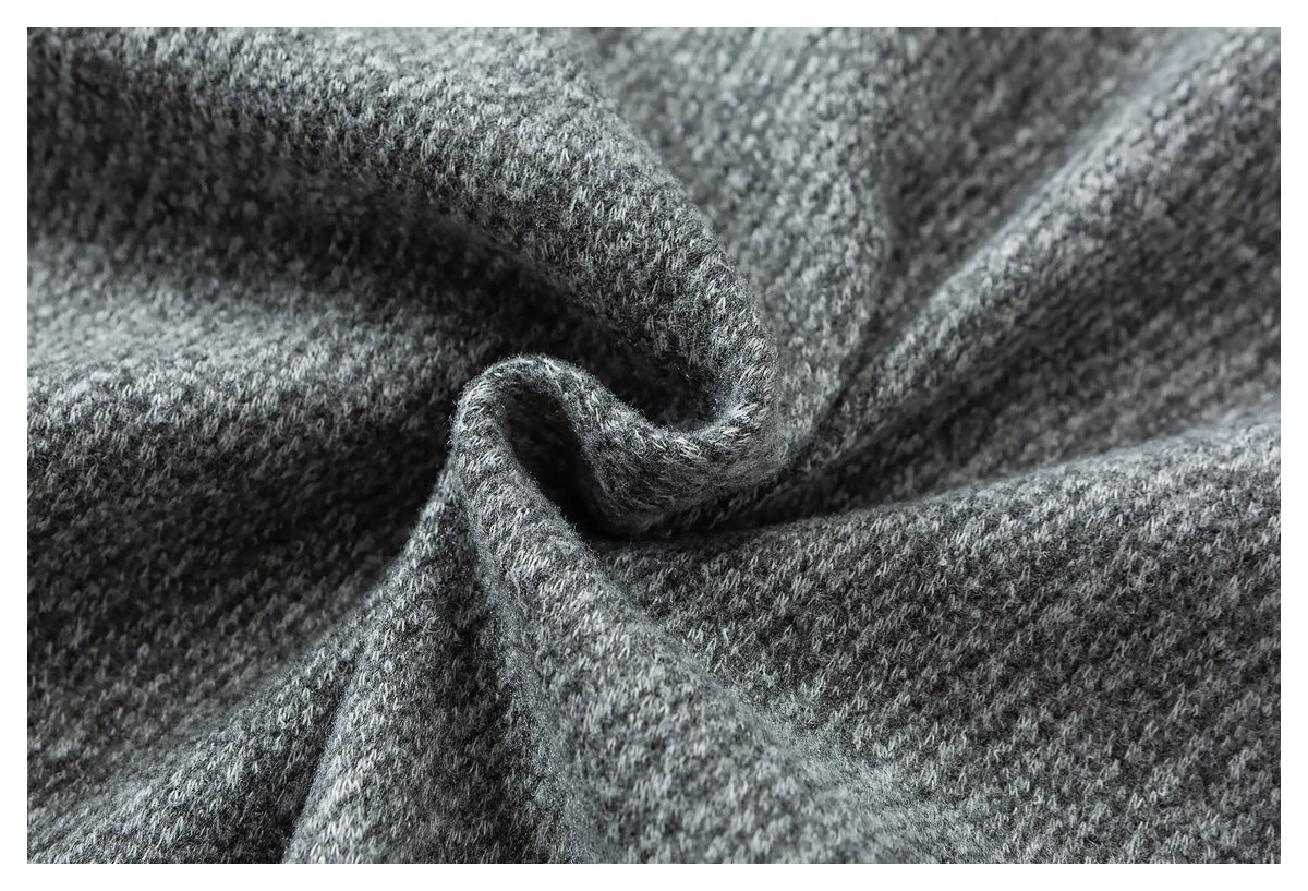Macro view of gray textured fabric gathered into soft folds.