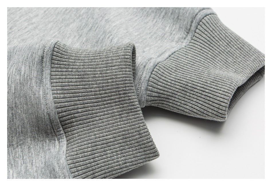Close-up of two ribbed gray cuffs on a heather-gray garment.