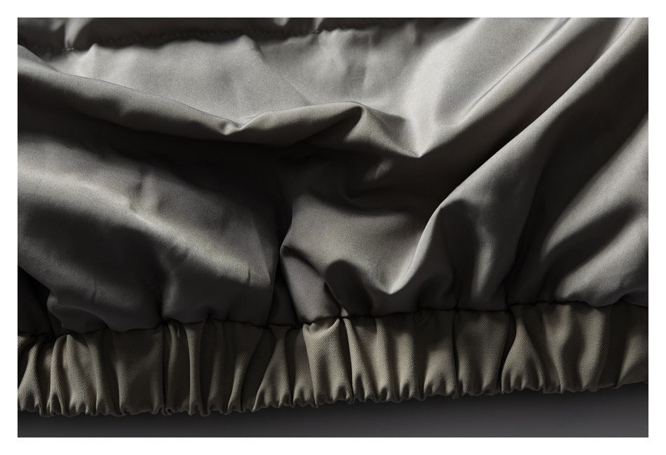 Close-up of a taupe garment's gathered elastic hem.