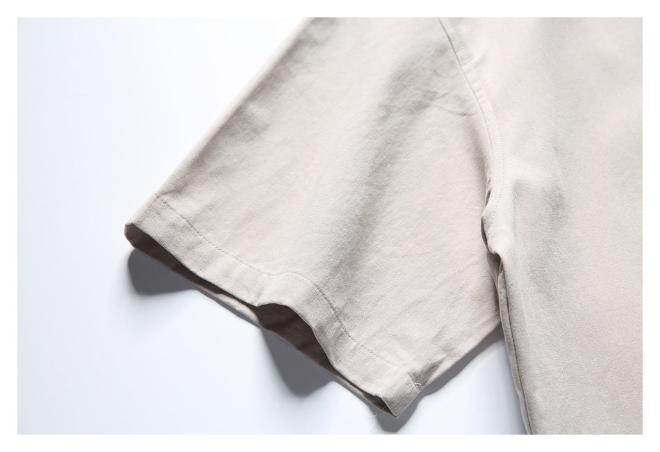 Close-up of a short sleeve and seam on a light beige shirt.