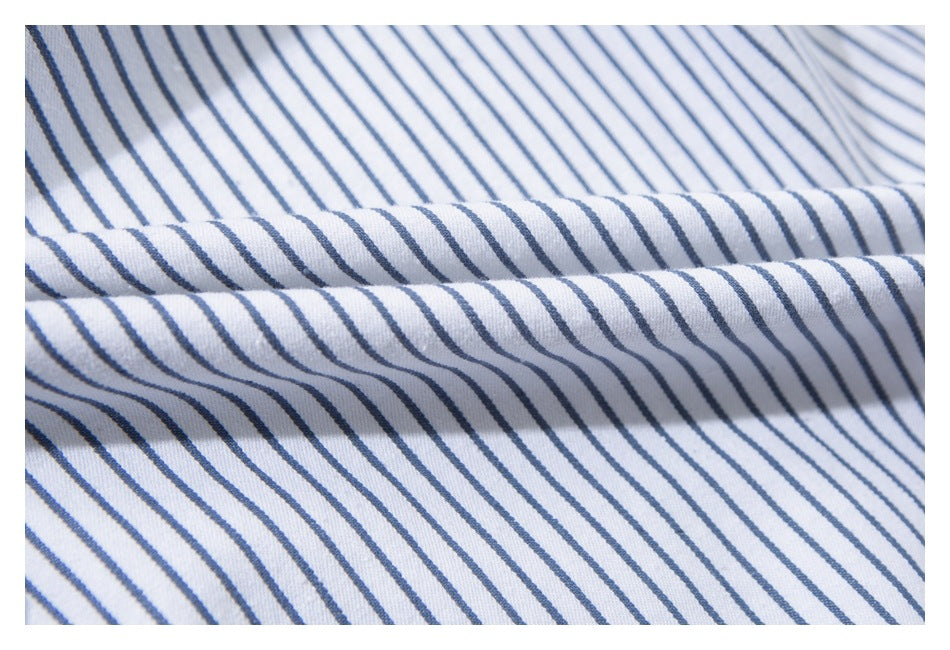 Close-up of white fabric with narrow blue stripes gathered into soft folds.