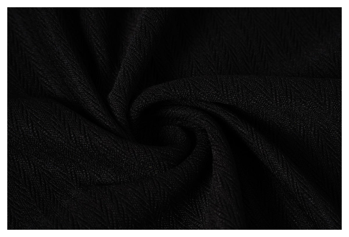 Close-up of black fabric with a subtle raised textured pattern.