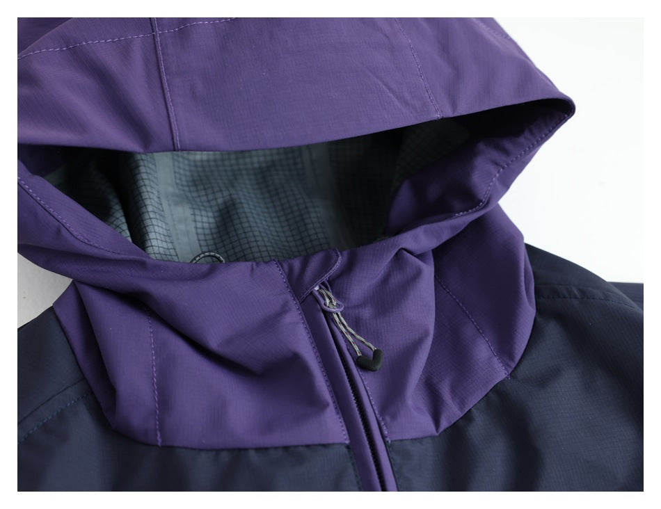 Close-up of a purple jacket hood with gridded lining, drawcord and front zipper against a dark navy body.