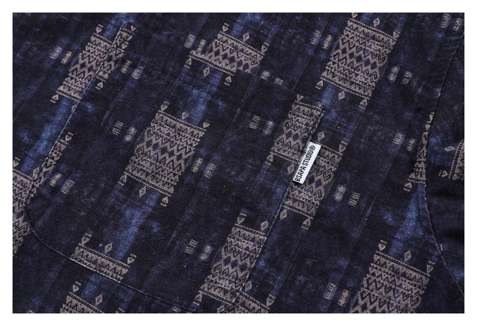 Close-up of the patterned shirt's chest pocket and small sewn-in label.