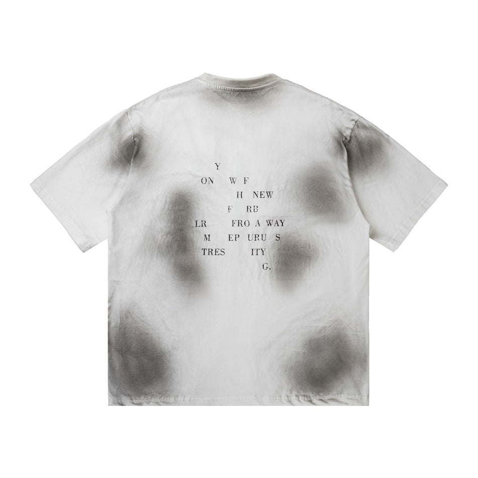 Back of a white short-sleeve T-shirt with gray faded patches and small centered black lettering.