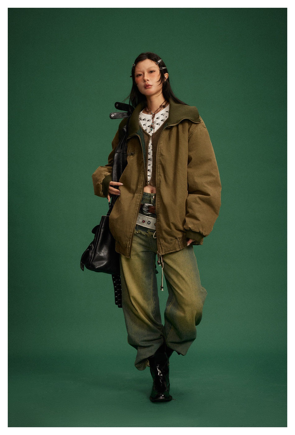 Model wears an oversized olive-brown zip jacket with a dark green ribbed collar, elastic cuffs, and hem.