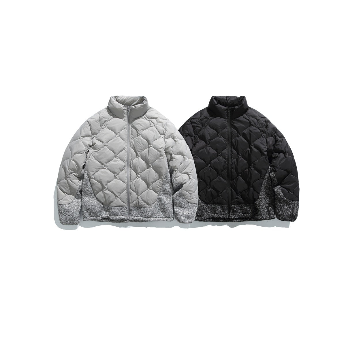Two front-view quilted zip jackets: light gray and black, each with mottled gray knit lower panels.