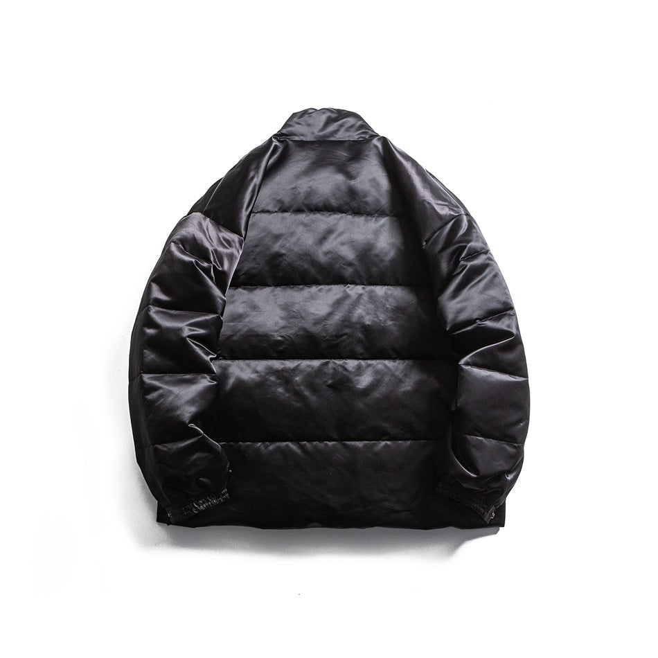 Back view of a black padded jacket with horizontal quilting and gathered cuffs, laid flat.