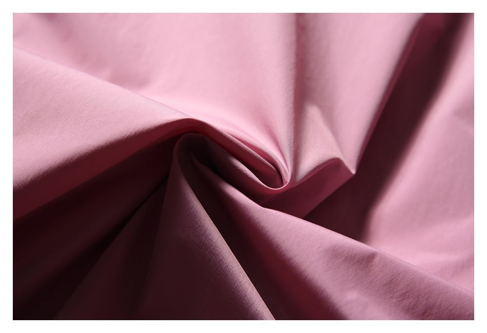Close-up of pink fabric gathered into soft folds.