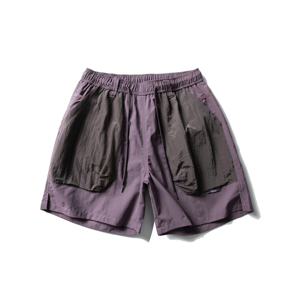 Purple drawstring shorts with large gray-brown crinkled patch pockets, flat lay front view